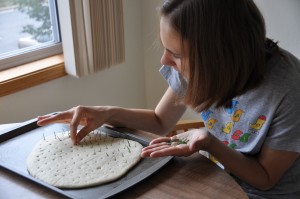 Placing Rosemary in Pizza Caccia Nanza